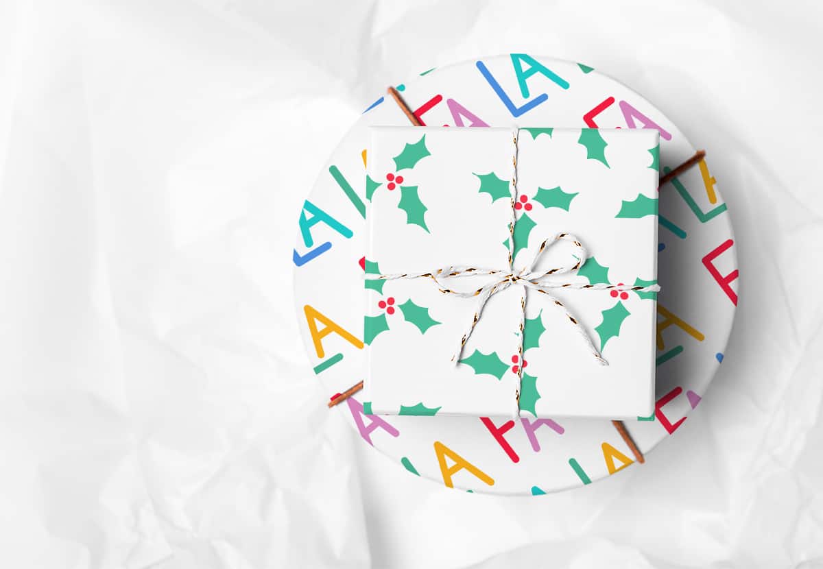 Two packages wrapped in festive wrapping paper on a white background.