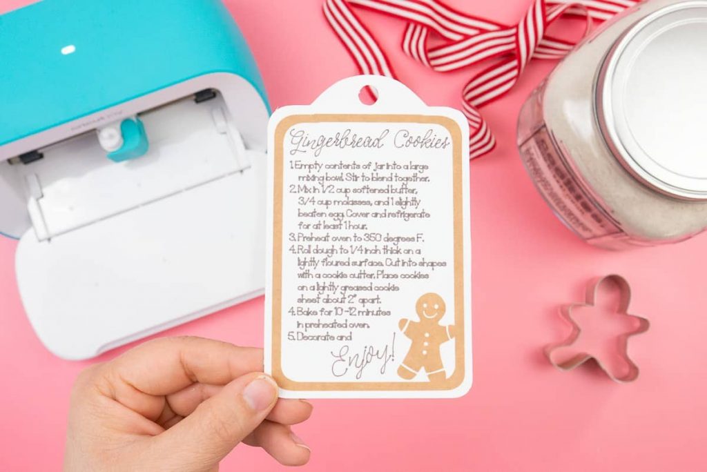 Hand holding a tag with instructions on how to use Gingerbread Cookies In A Jar Holiday Gift.